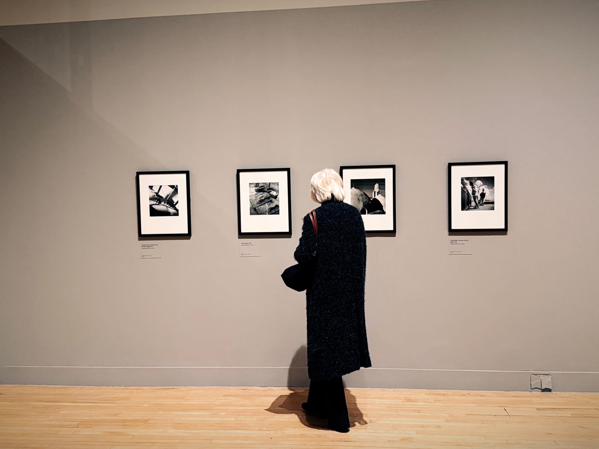 Women looking at displayed images on wall